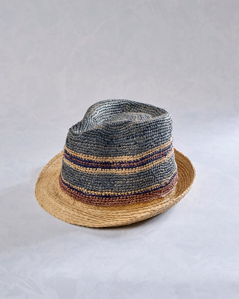 Crochet fedora with a natural-colored brim and gray crown featuring blue and tan horizontal stripes.