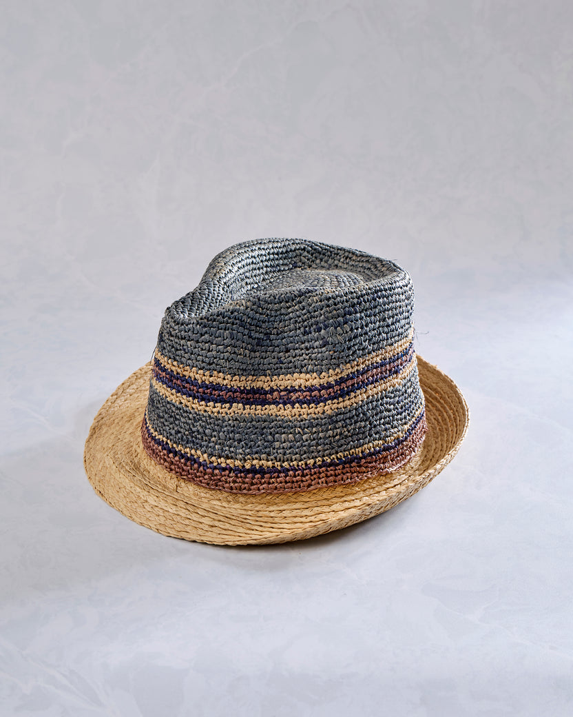 Crochet fedora with a natural-colored brim and gray crown featuring blue and tan horizontal stripes.