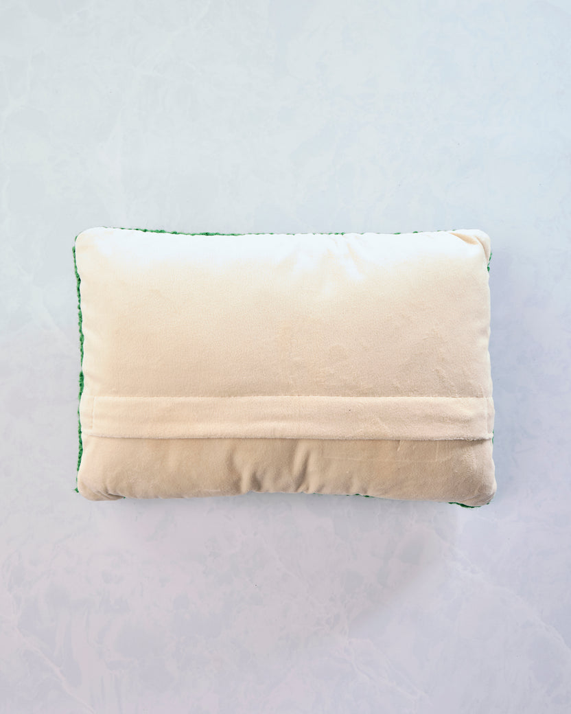Back of the rectangular golf-tees pillow showing a cream-colored backing with a horizontal seam.
