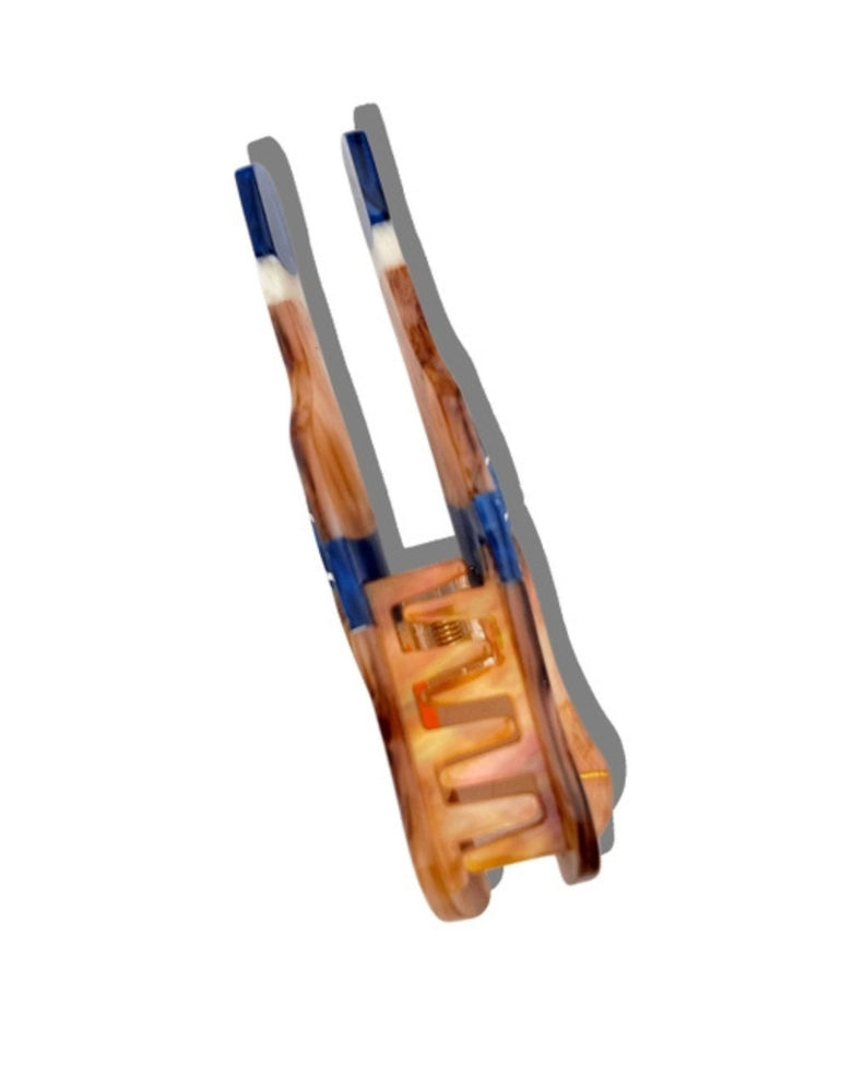 Side view of the bottle-shaped claw hair clip showing its interlocking teeth and clasp mechanism.