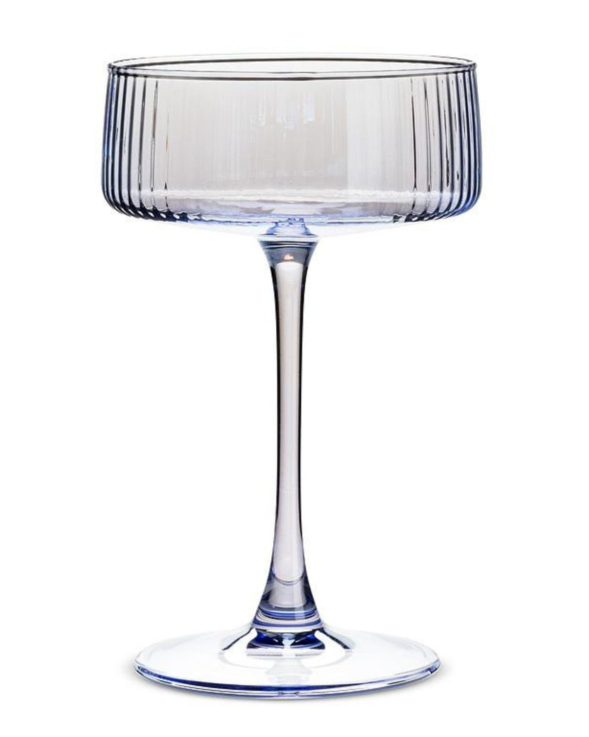 Single clear blue ribbed cocktail coupe glass with a long stem and round base.