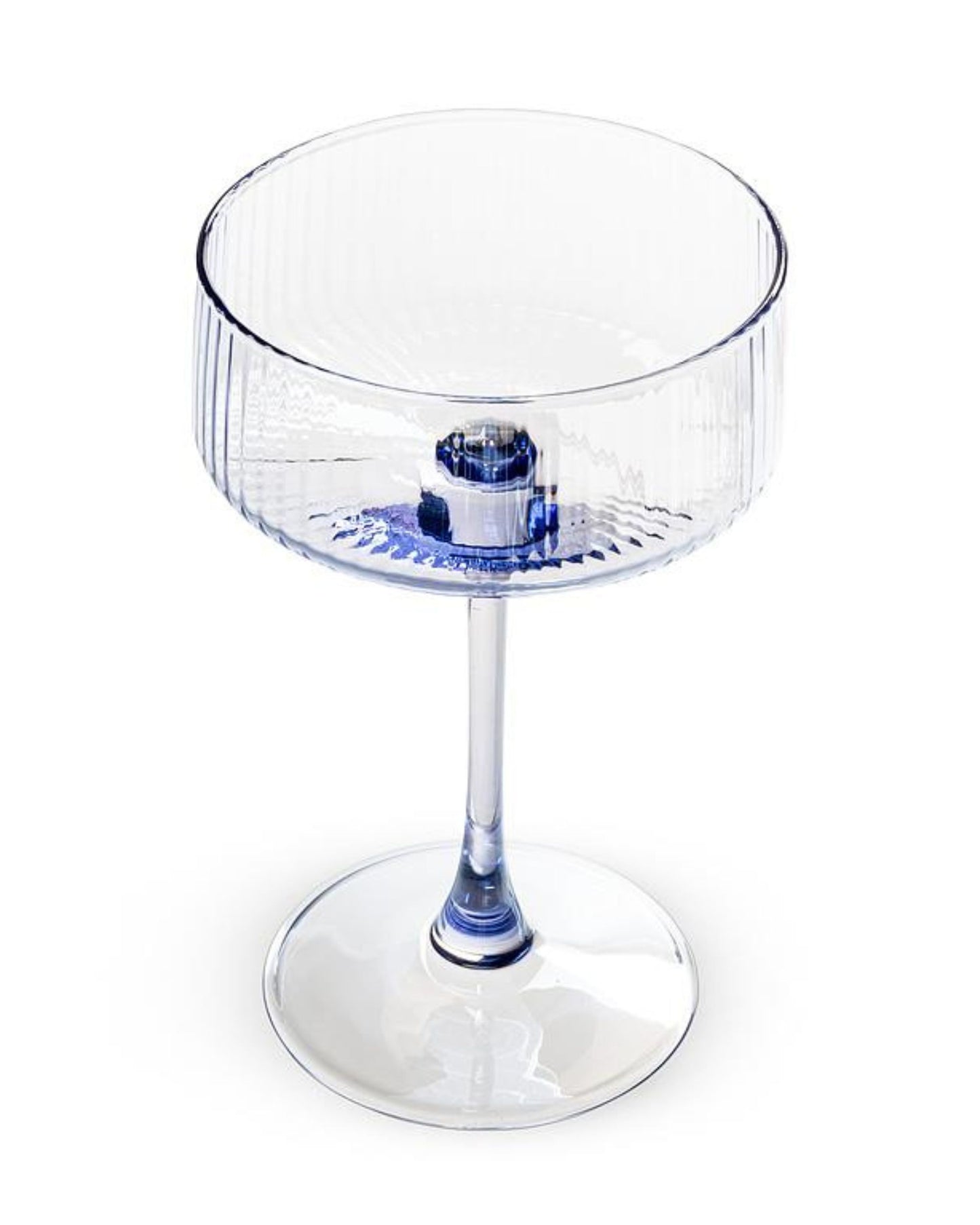 Angled view of a clear blue ribbed cocktail coupe glass showing the open bowl, stem, and round base.