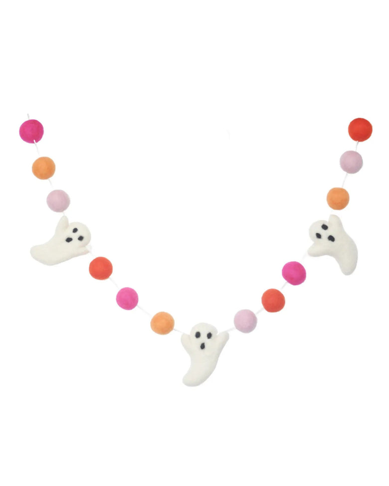 Garland of white ghost shapes and pink, orange, and coral felt balls arranged in a curved line.