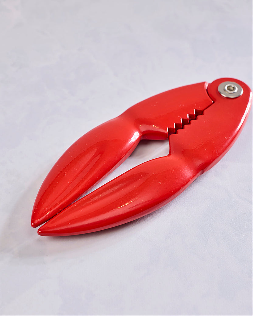 Red lobster-shaped shell cracker shown closed at an angle.