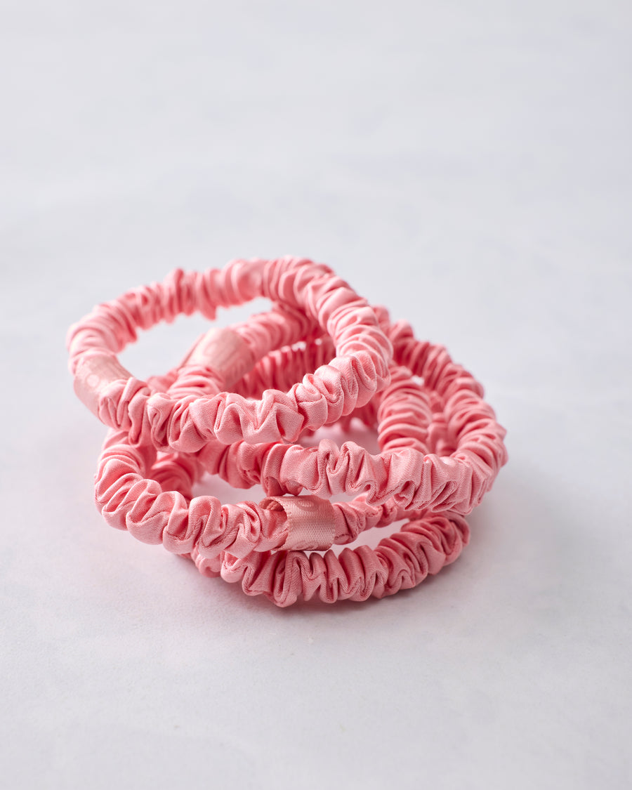 Four rose skinny scrunchies removed from the packaging and overlapping