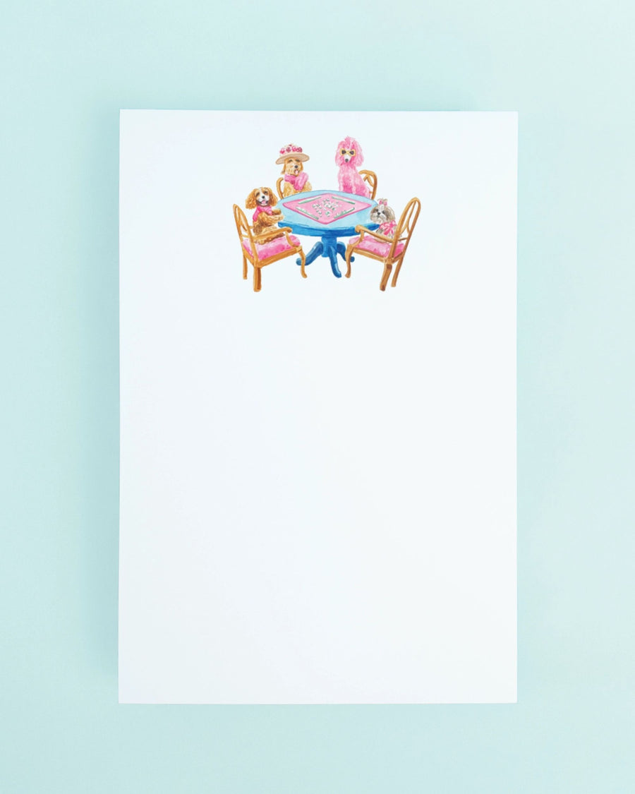 White top-bound notepad with an illustration of dogs seated around a blue table playing mahjong.