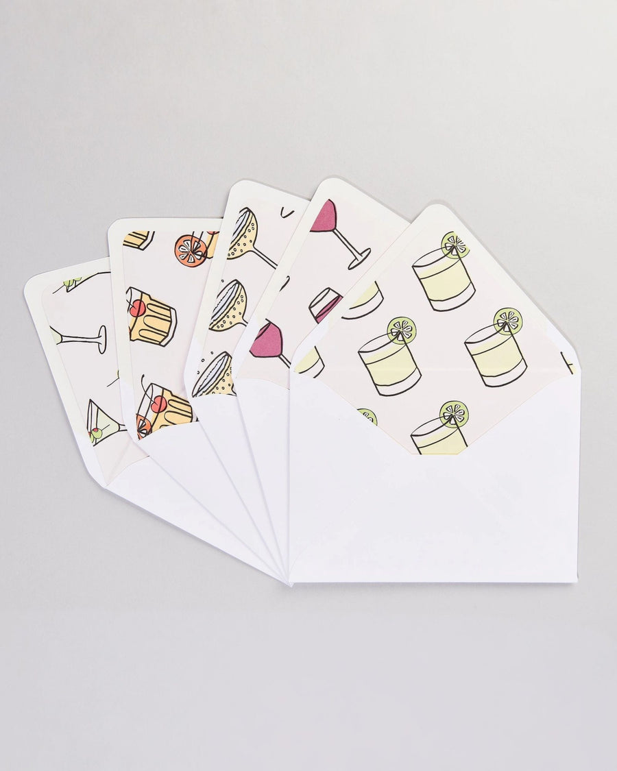 Set of white envelopes and cards with colorful cocktail and drink illustrations arranged in a fan.