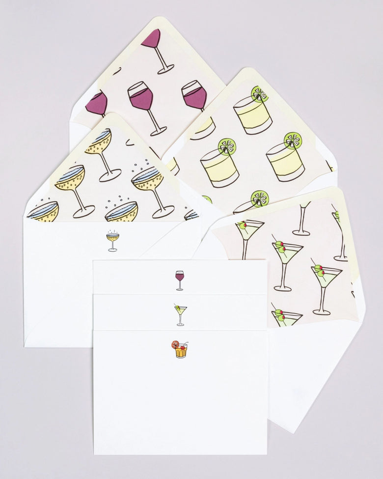 Happy Hour notecard set with white envelopes and cards featuring repeated illustrations of cocktails, wine glasses, and lime drinks.