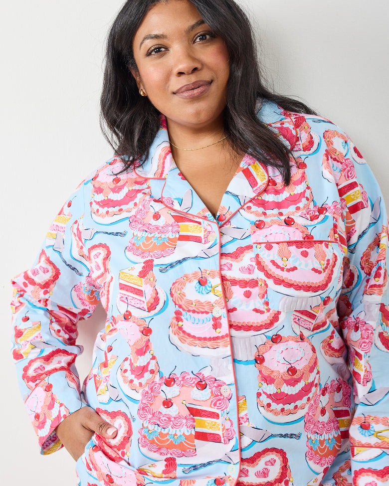 Front detail of the blue button-front pajama top with pink cake and cherry print