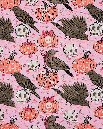 Sleepy Hollow print with black birds, white skulls, and ribboned orange pumpkins on pink